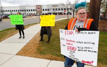 工人们在公司大楼外抗议，要求更好地防范冠状病毒