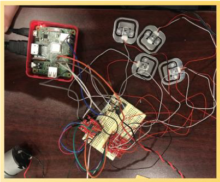 Arduino与黑色、红色,电线导致负载细胞测试阅读在原型一个棕色的桌子上。